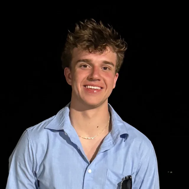 Jacob Krzynowek, founder of TandemPartners, smiling, in a light blue button-down shirt